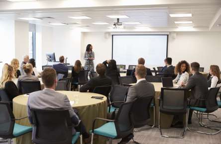 Businesswoman Making Presentation At Conference